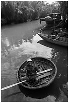 Man in circular boat near Cam Kim Village. Hoi An, Vietnam ( black and white)