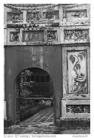 Palace gate with ceramic decorations, citadel. Hue, Vietnam (black and white)