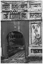Palace gate with ceramic decorations, citadel. Hue, Vietnam (black and white)