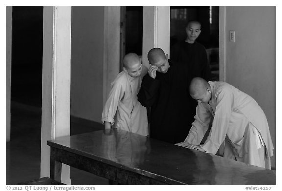 Monks looking at book, Thien Mu pagoda. Hue, Vietnam (black and white)