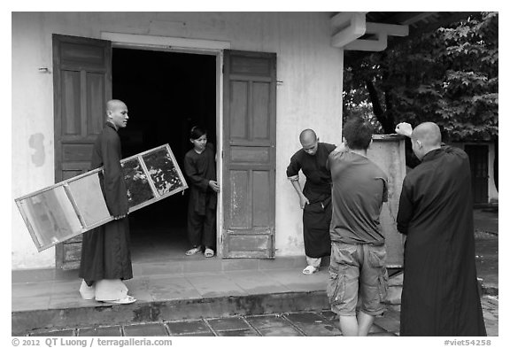 Monks carrying furniture, Thien Mu pagoda. Hue, Vietnam (black and white)
