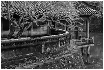 Luu Khiem Lake edge with stone fence and pavilion, Tu Duc Tomb. Hue, Vietnam (black and white)