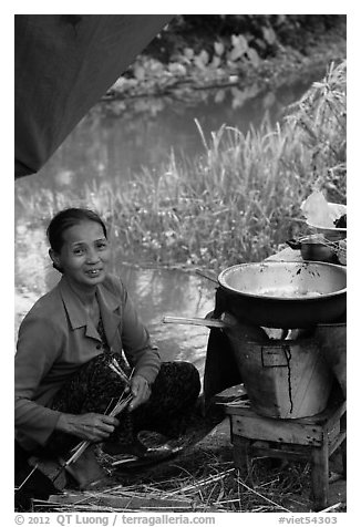 Woman cooking canalside, Thanh Toan. Hue, Vietnam