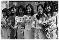 Row of women in Ao Dai, Temple of the Litterature. Hanoi, Vietnam (black and white)