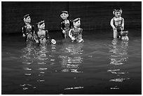 Water puppets (5 characters with musical instruments), Thang Long Theatre. Hanoi, Vietnam (black and white)