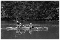Sea kayakers on emerald waters. Halong Bay, Vietnam (black and white)