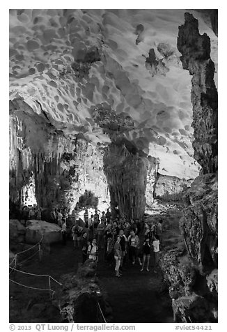 Tourists in first grotto, Surprise Cave. Halong Bay, Vietnam (black and white)