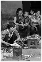 Woman roasting corn in the street. Bat Trang, Vietnam ( black and white)