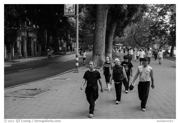 Numerous people walk counter-clockwise around Hoang Kiem Lake. Hanoi, Vietnam