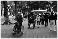 Elderly women pushing their wheelchairs while walking for exercise. Hanoi, Vietnam (black and white)