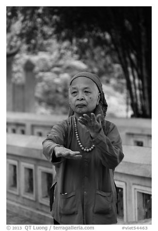 Elderly woman doing Tai Chi moves. Hanoi, Vietnam (black and white)