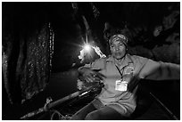Woman boater in narrow cave passage, Trang An. Ninh Binh,  Vietnam (black and white)