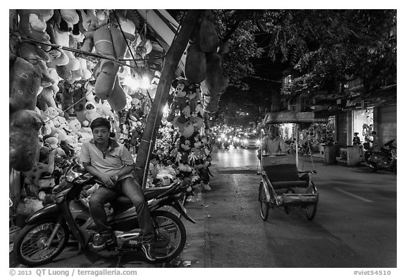 Street at night with motorcycle and cyclo, old quarter. Hanoi, Vietnam (black and white)