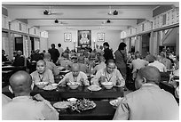 Monks and nuns having diner, An Quang Pagoda, district 10. Ho Chi Minh City, Vietnam (black and white)