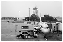 Airliner and control tower, Tan Son Nhat airport, Tan Binh district. Ho Chi Minh City, Vietnam (black and white)