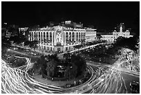Traffic circle with light trails, Rex Hotel and City Hall. Ho Chi Minh City, Vietnam (black and white)
