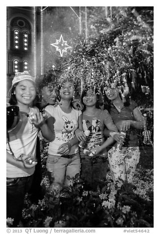 Young Revellers in front of Notre Dame Cathedral on Christmas Eve. Ho Chi Minh City, Vietnam (black and white)