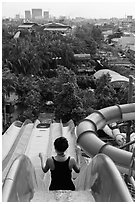 Woman on tall water slide, Dam Sen Water Park, district 11. Ho Chi Minh City, Vietnam (black and white)