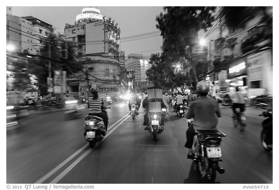 View from middle of street traffic at dusk. Ho Chi Minh City, Vietnam