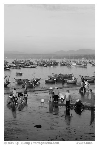 Miror-like beach and fishing boats, early morning. Mui Ne, Vietnam (black and white)