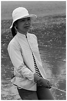 Fisherwoman pulling net line. Mui Ne, Vietnam (black and white)