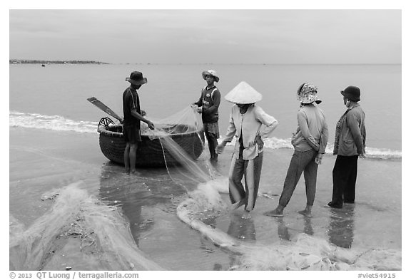 Fishermen, net, and coracle boat. Mui Ne, Vietnam