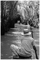 Padding in mangrove-lined narrow waterway, Phoenix Island. My Tho, Vietnam (black and white)