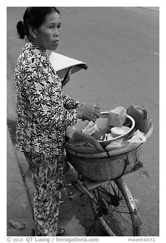 Woman vending food out of bicycle. Tra Vinh, Vietnam (black and white)