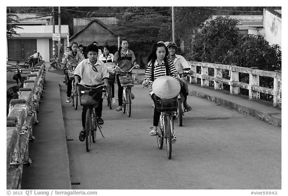 Children bike on way to school, Phung Diem. Can Tho, Vietnam