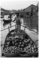 Woman paddles boat loaded with fruits and vegetable, Phung Diem. Can Tho, Vietnam ( black and white)