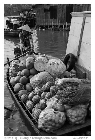 Woman paddles boat fully loaded with produce, Phung Diem. Can Tho, Vietnam