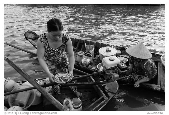 Woman gets bowl of noodles from floating market. Can Tho, Vietnam