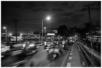 Evening traffic by the canal, District 8. Ho Chi Minh City, Vietnam ( black and white)
