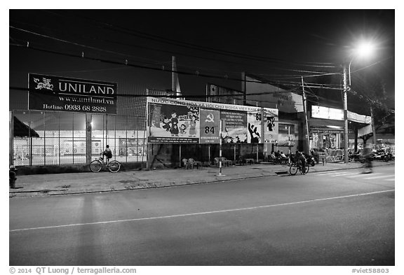 Street and stadium at night, District 8. Ho Chi Minh City, Vietnam (black and white)