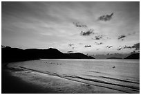 Con Son Beach with people in water before sunrise. Con Dao Islands, Vietnam ( black and white)