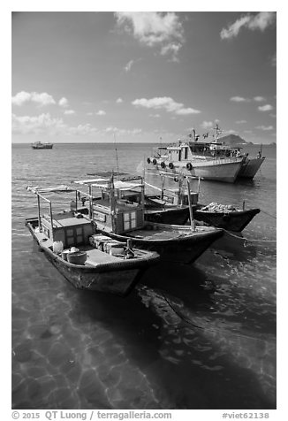 Fishing boats floating on clear water, Con Son. Con Dao Islands, Vietnam (black and white)