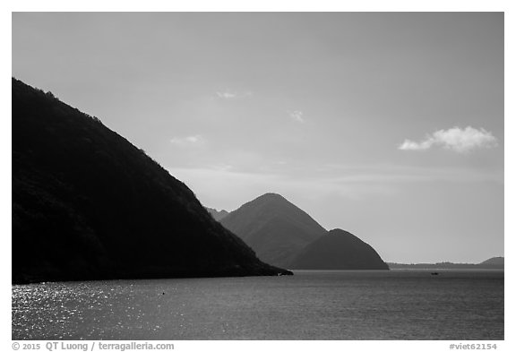 Hills plunging in sea, Bay Canh Island, Con Dao National Park. Con Dao Islands, Vietnam (black and white)