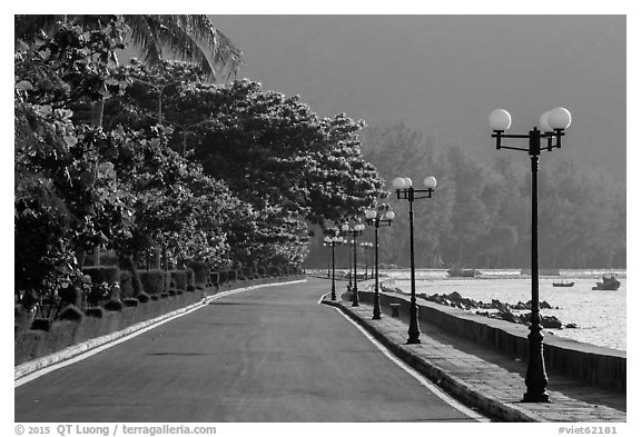Deserted seafront promenade lined up with lamps, Con Son. Con Dao Islands, Vietnam (black and white)