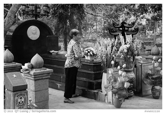 Woman offers incense at Vo Thi Sau grave. Con Dao Islands, Vietnam (black and white)