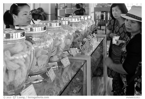 Women buying eddible birds nest. Con Dao Islands, Vietnam (black and white)