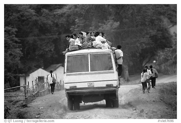 Passengers sitting on top of an overloaded bus. Northest Vietnam (black and white)