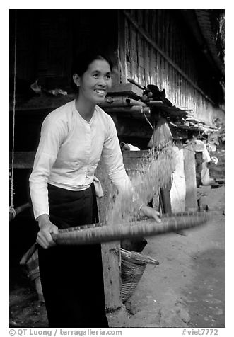 Woman of the Thai ethnicity sorting grain, near Mai Chau. Vietnam (black and white)