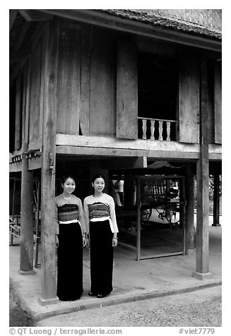Two thai women standing in front of their stilt house, Ban Lac village. Northwest Vietnam