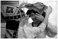 A thai woman helps her friend with her elaborate headdress, Son La. Northwest Vietnam (black and white)