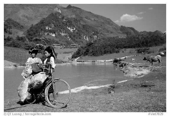 Thai women load a bicycle, near Tuan Giao. Northwest Vietnam (black and white)
