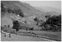Two montagnards walking down a field, between Tuan Giao and Lai Chau. Northwest Vietnam ( black and white)