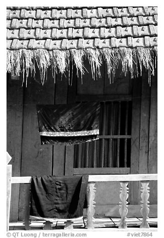 Detail of hut with montagnard dress being dried, between Tuan Giao and Lai Chau. Northwest Vietnam