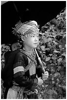 Hmong girl sheltering herself and her younger sibling with an unbrella, between Lai Chau and Tam Duong. Northwest Vietnam (black and white)