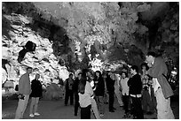 Tourists in illuminated cave. Halong Bay, Vietnam ( black and white)