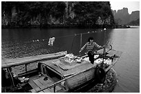 Peddling from a boat. Halong Bay, Vietnam (black and white)